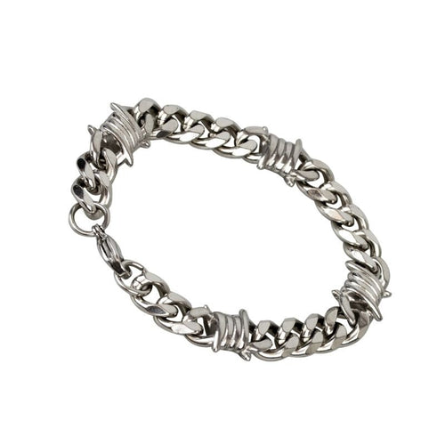 Bracelet made of polished stainless steel, curb chain with barbed wire elements and carabiner clasp. Width: 10 mm, Length: 18 cm + 2 cm extension.