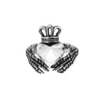 This traditional Irish wedding ring features a distinctive design of skeleton hands, symbolizing eternal love and loyalty. With a height of approximately 2.0 cm, it is a visually striking and meaningful addition to any alternative jewelry collection.