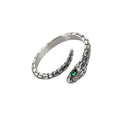 This stainless steel snake ring features stunning green zirconia eyes, perfect for adding a touch of rock style to any outfit. Made from durable materials, this ring is a striking addition to any accessory collection.