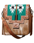 A boho style shoulder bag with hand-punched cowhide design, featuring turquoise textile inserts and fringing, with a detachable shoulder strap.