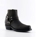 Premium Brown Leather Western Ankle Boots with Harness. Discover the iconic Renegade Lo Western ankle boots in rich brown leather, a perfect fusion of classic cowboy style and modern rock edge. These premium boots feature distinctive harness straps, slip-on convenience, and versatile unisex styling that works for both men and women who appreciate authentic Western aesthetics with contemporary attitude.